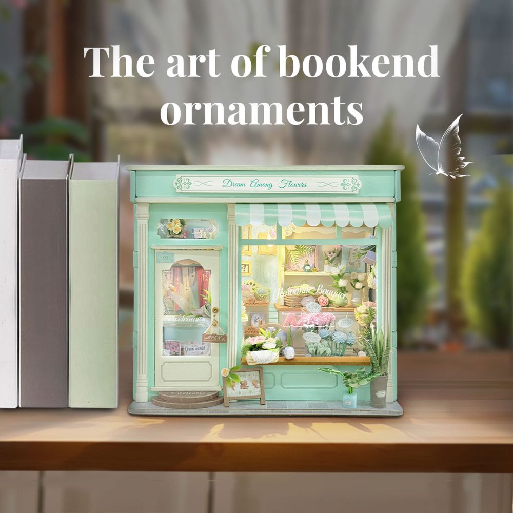 The storefront is filled with intricate miniature elements, including various colorful bouquets, potted plants, shelving units, and a "Welcome" sign on the door.