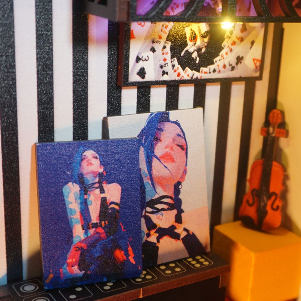 The scene is themed around the girl. The pictures on the walls and the table also about the girl and a miniature violin is also part of the display.
