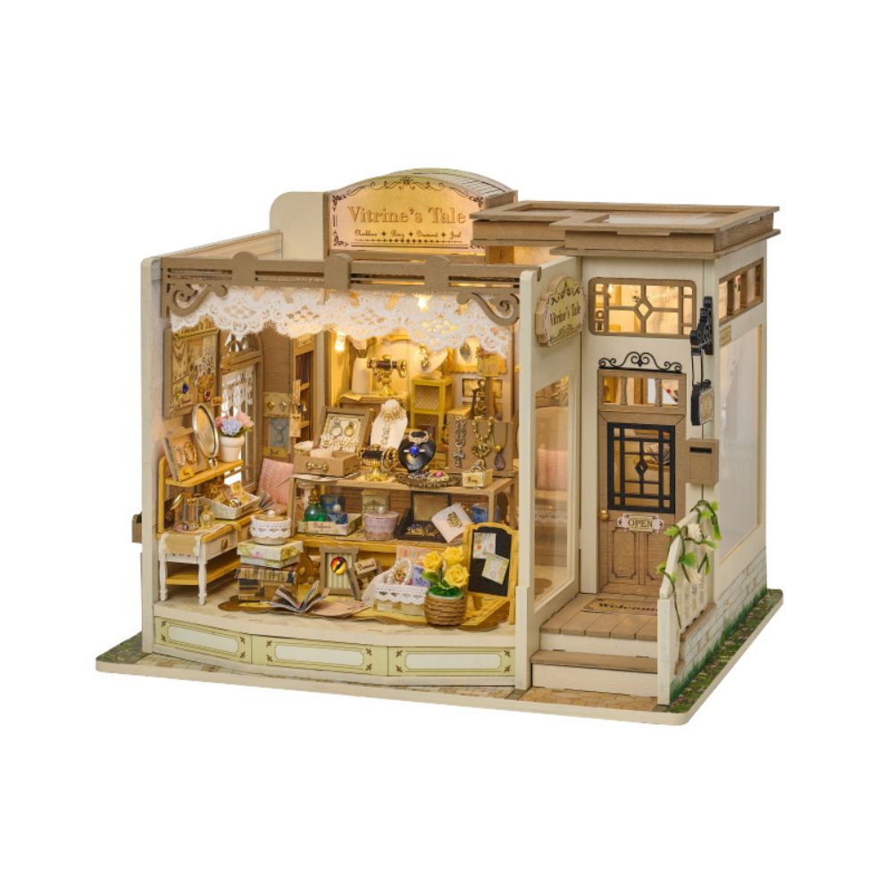 The building has a classic architectural style with a sign above the entrance reading "Vitrine's Tale". A small "OPEN" sign is visible on the glass door, and there are steps leading up to the entrance.