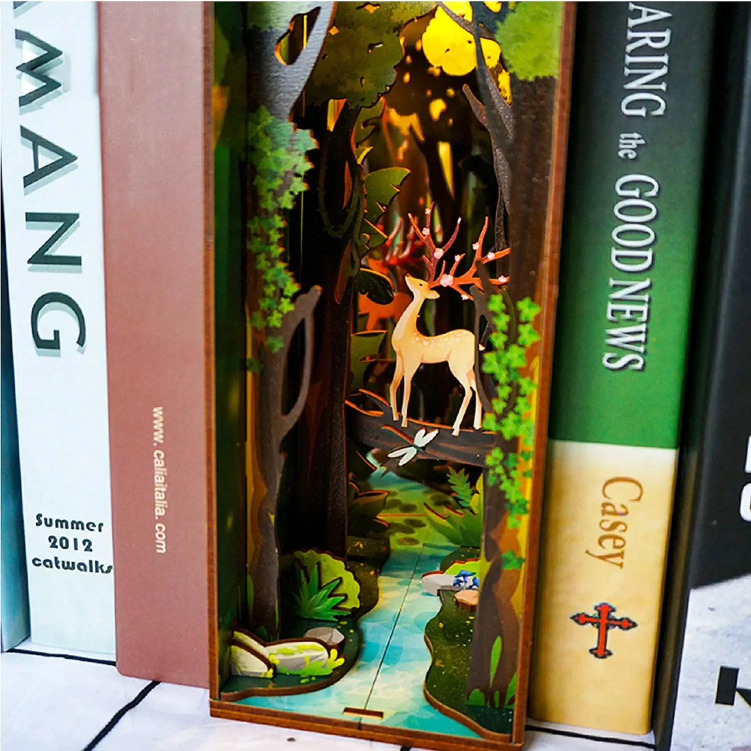 Story of The Forest DIY Book Nook Kit with miniature trees, cozy cabin, and detailed accessories for creative shelving.
