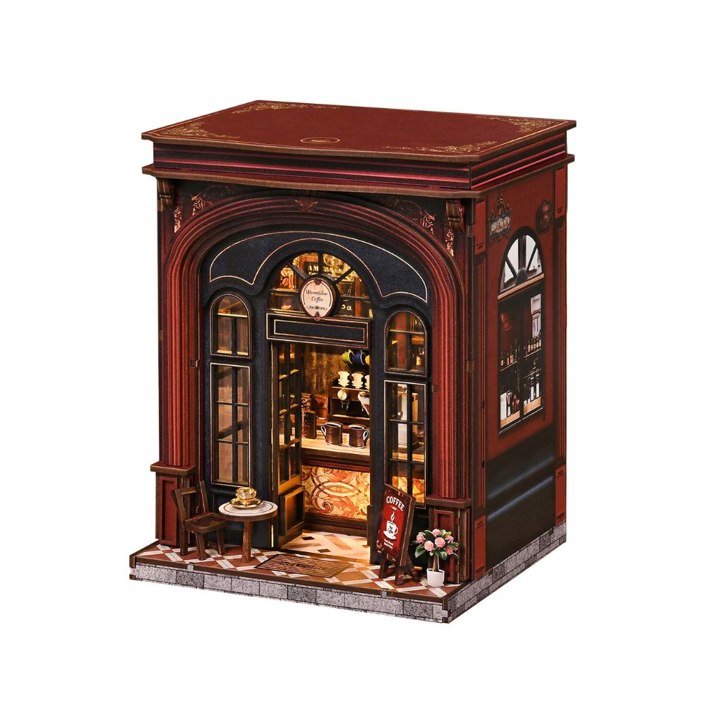 The assembled model depicts a detailed, vintage-style coffee shop facade and interior scene. 