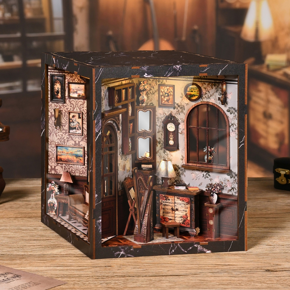 This photo shows a miniature vintage study with warm, detailed décor. The room features floral wallpaper, framed paintings, a wooden cabinet, lamps, and chairs, creating a cozy, nostalgic atmosphere. It looks like a tiny book nook or diorama of an old-fashioned living space.