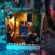 The diorama features a piano, a dining table with two blue chairs, and various decorative elements.
The overall aesthetic is described as bold, joyful, and designed to make people rethink what a space can be.