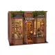 It is a 3D wooden puzzle that, once assembled, creates a miniature scene designed to fit between books on a shelf.