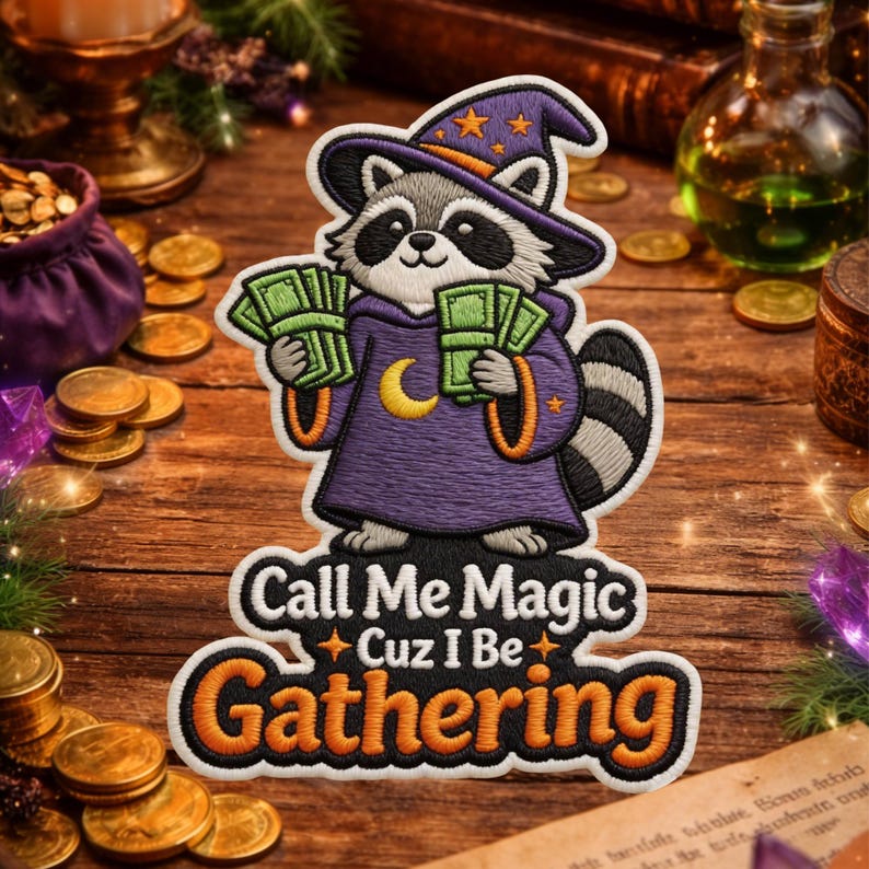 May include: Embroidered patch featuring a raccoon dressed as a wizard, holding money. The raccoon wears a purple robe and a star-adorned hat. Text on the patch reads "Call Me Magic Cuz I Be Gathering."