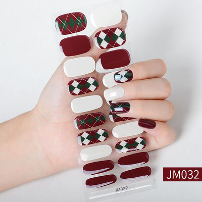 Christmas nail wraps featuring festive designs with Santa Claus, Christmas trees, and red, green, and white holiday colors.