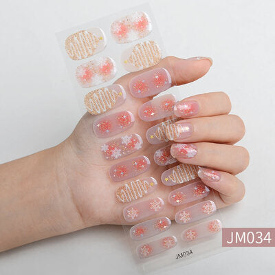 Christmas nail wraps featuring festive designs with Santa Claus, Christmas trees, and red, green, and white holiday colors.