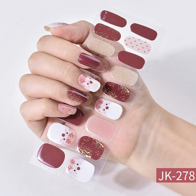 Christmas nail wraps featuring festive designs with Santa Claus, Christmas trees, and red, green, and white holiday colors.