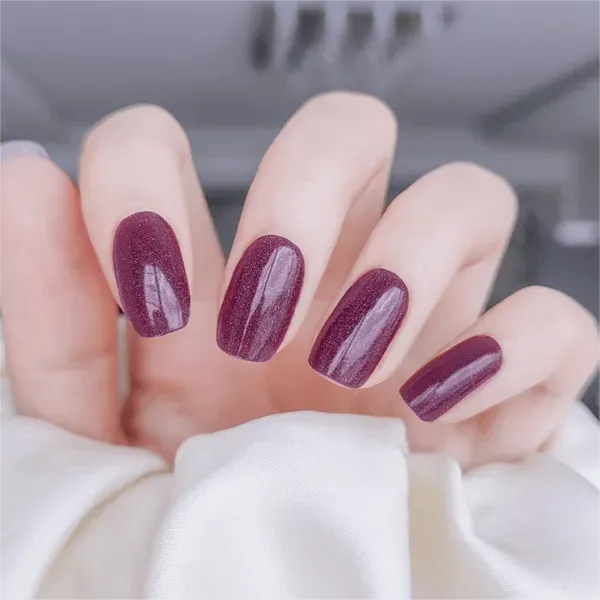 Berry Sparkle Gel Nail Wraps with glittering burgundy tones for a glamorous manicure.