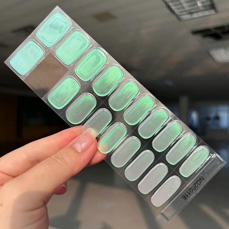 Emerald Glow Gel Nail Wraps with a shimmering green finish for an elegant and luxurious manicure.