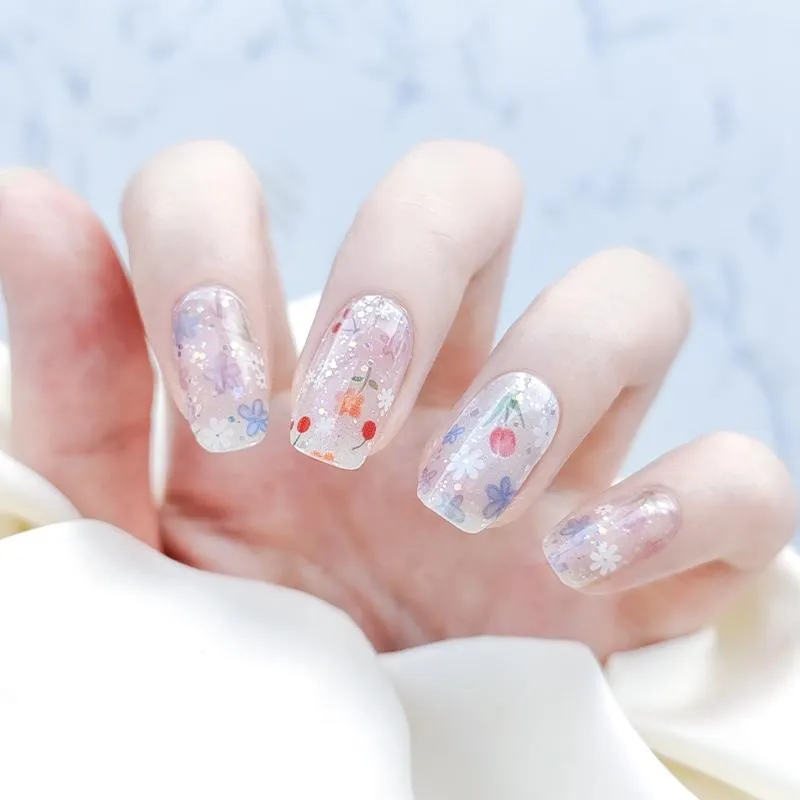 Floral transparent gel nail wraps featuring cherry blossoms and pastel flower designs.