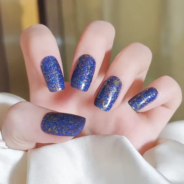 Galaxy Blue Glitter Gel Nail Wraps with cosmic-inspired sparkle and holographic details.