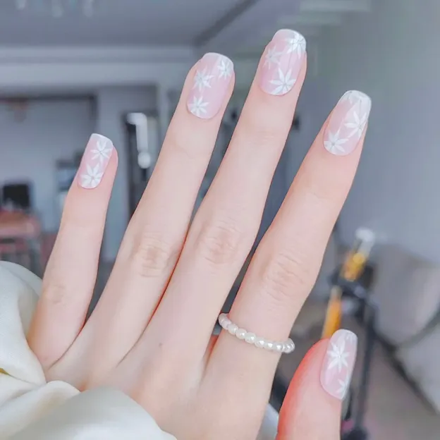 Gentle Pink Daisies Gel Nail Wraps featuring delicate white daisies on a pastel pink base for elegant semi-cured gel nail art.