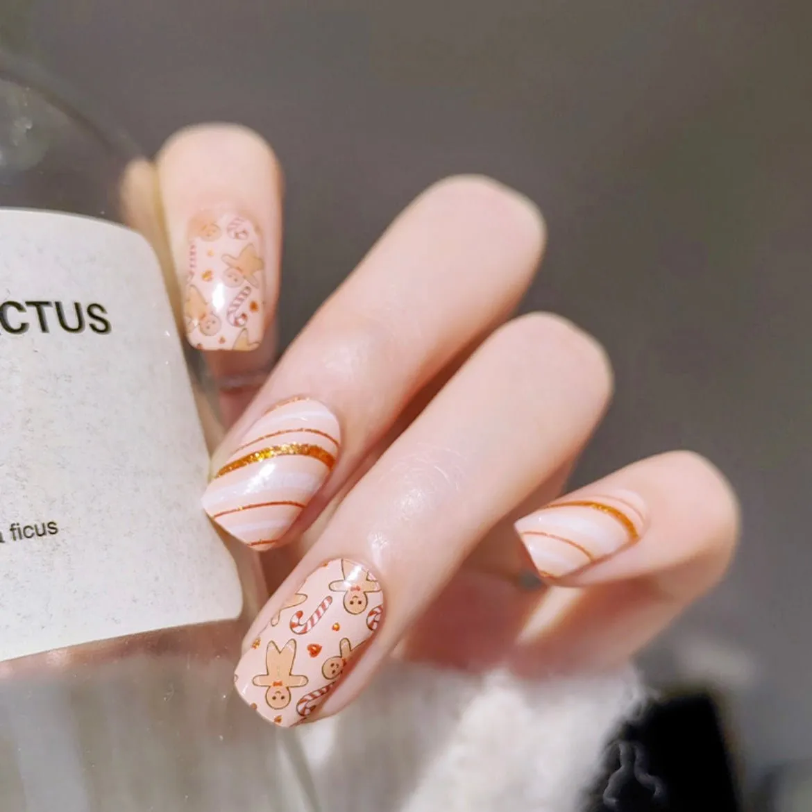 Gingerbread Holiday Gel Nail Wraps featuring gingerbread cookies and candy canes with festive sparkle.