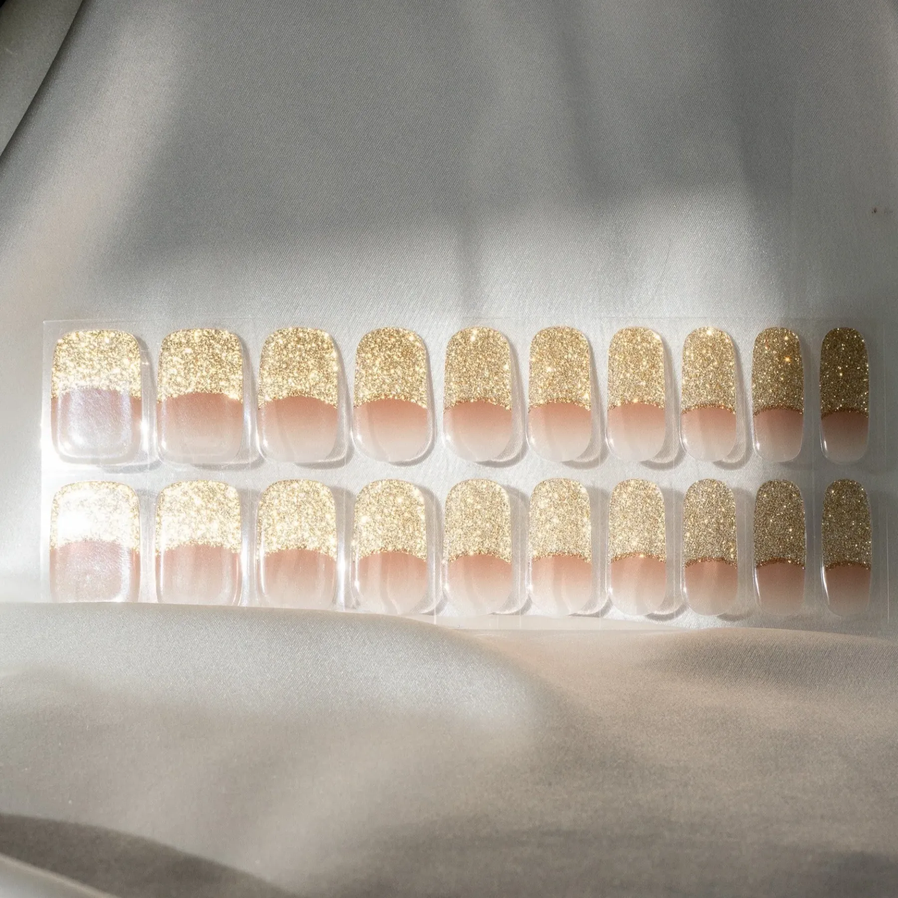 Golden Hour French Tip Gel Nail Wraps featuring a luxurious golden glitter finish for an elegant and timeless manicure.