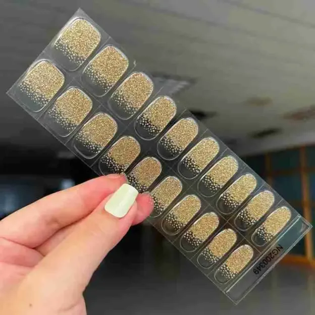 Golden Stardust Gel Nail Wraps with glittering gold design for an elegant manicure.