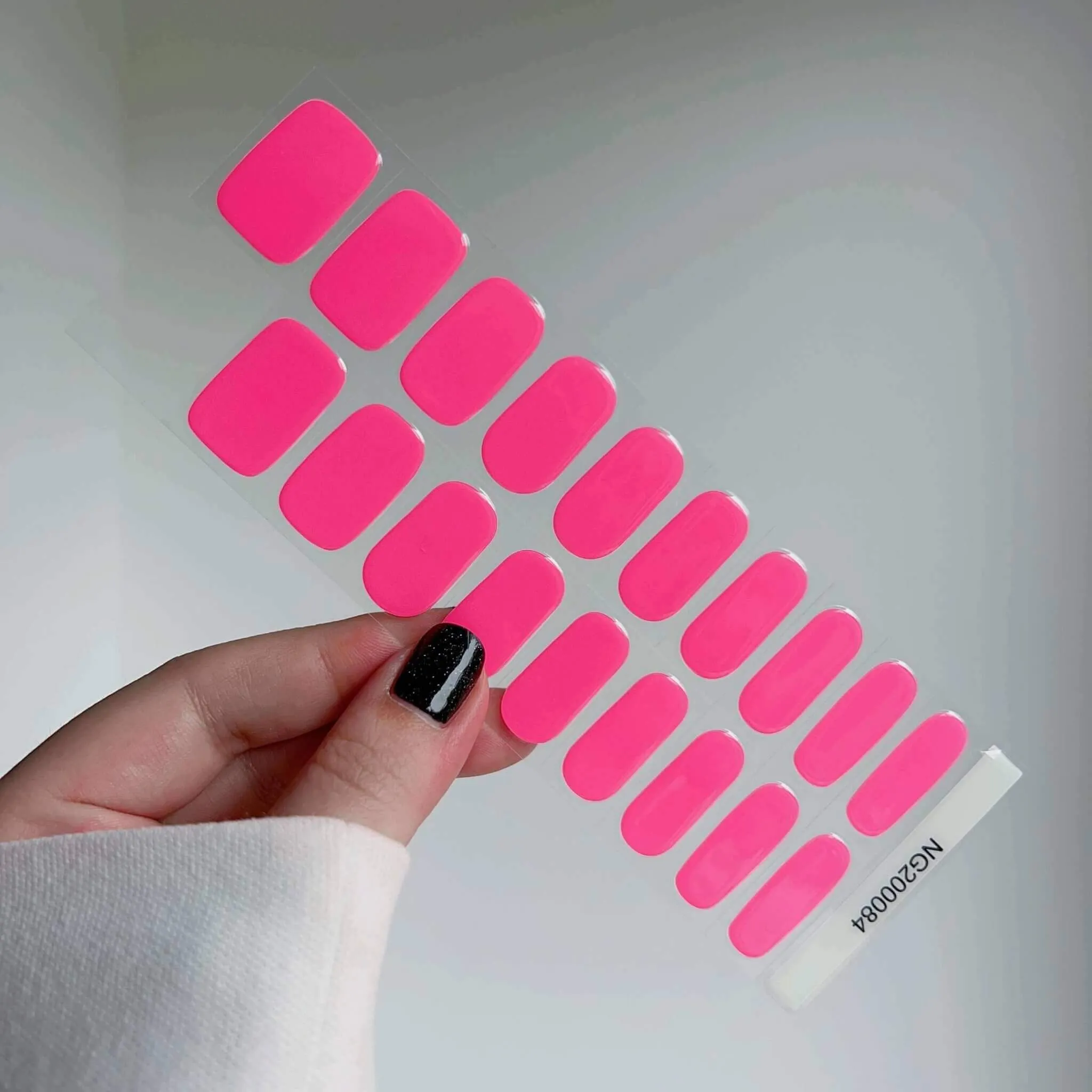 Hot pink gel nail wraps with a glossy finish for bold and vibrant nails.