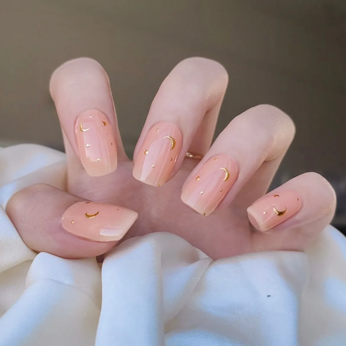 Little Venus Gel Nail Wraps featuring a celestial moon and star design in golden accents for semi-cured gel nails.