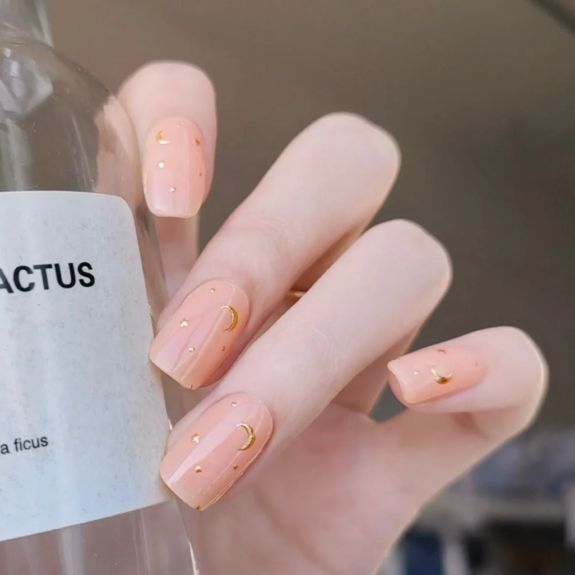 Little Venus Gel Nail Wraps featuring a celestial moon and star design in golden accents for semi-cured gel nails.