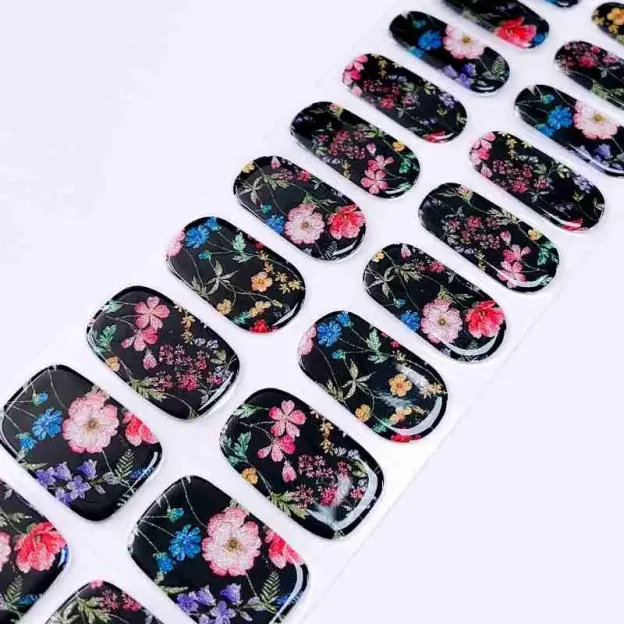 Midnight Bloom Gel Nail Wraps featuring a bold black base with vibrant floral designs for an elegant manicure.