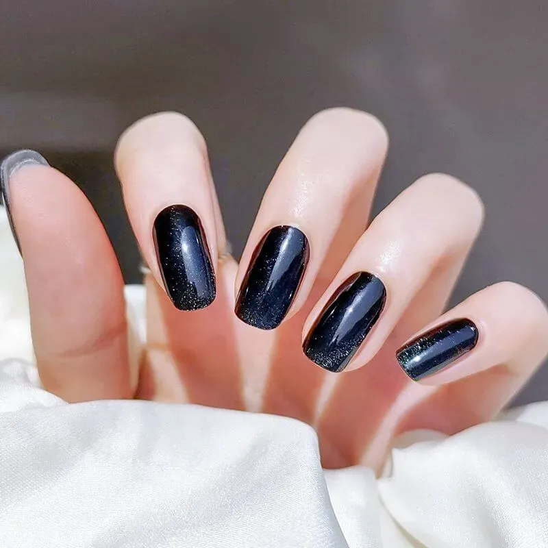 Midnight Luxe Gel Nail Wraps with a glossy black cat-eye shimmer finish for a bold and dramatic manicure.