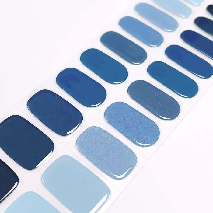 Ocean Hues Gel Nail Wraps featuring a stunning gradient of blue tones for a sophisticated and stylish look.