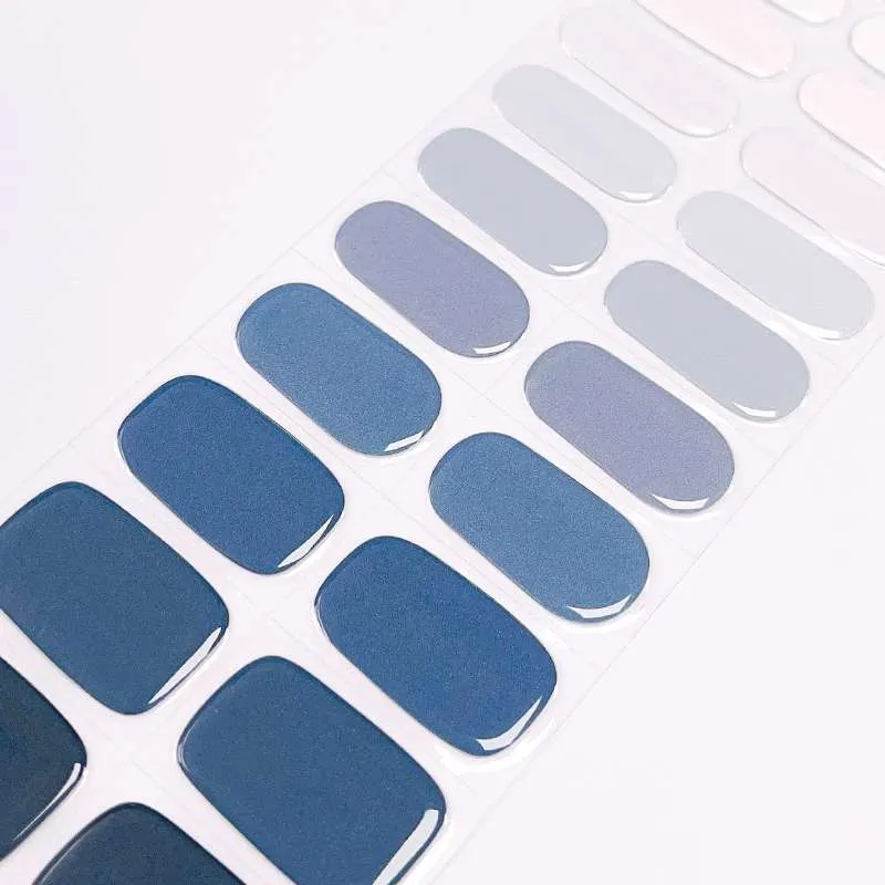 Ocean Twilight Gel Nail Wraps featuring a gradient from sky blue to navy for an elegant manicure.