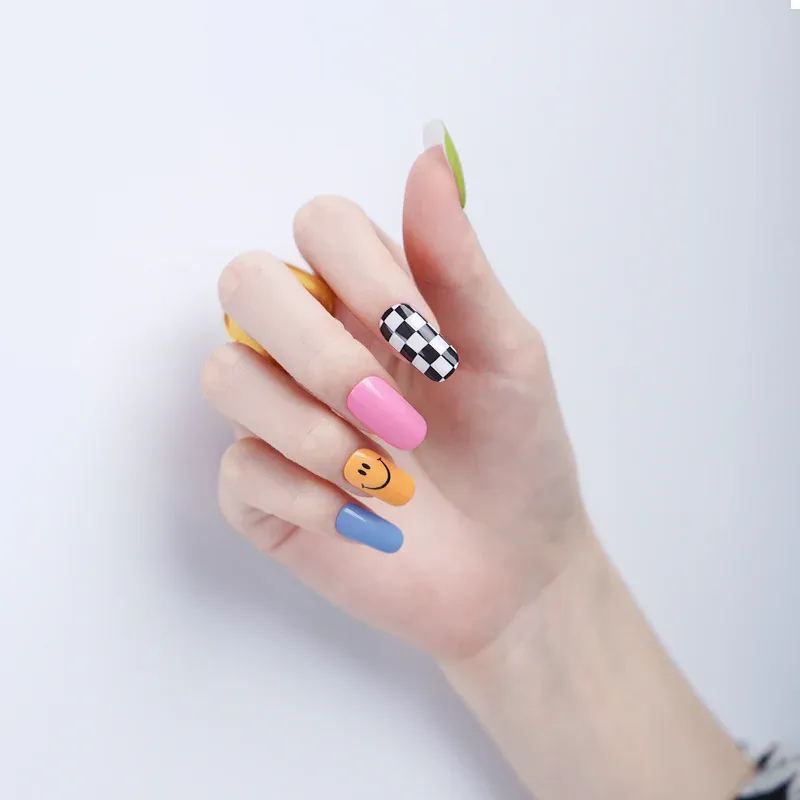 Playful Pop Art Gel Nail Wraps featuring vibrant colors, checkered designs, and smiley faces for a bold manicure.