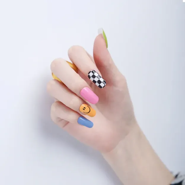Playful Pop Art Gel Nail Wraps featuring vibrant colors, checkered designs, and smiley faces for a bold manicure.