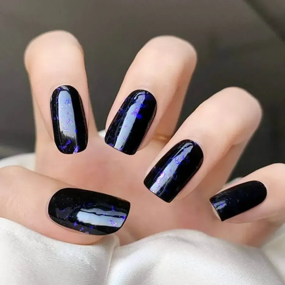 Purple Galaxy Gel Nail Wraps with a cosmic black and purple design for a starry manicure.