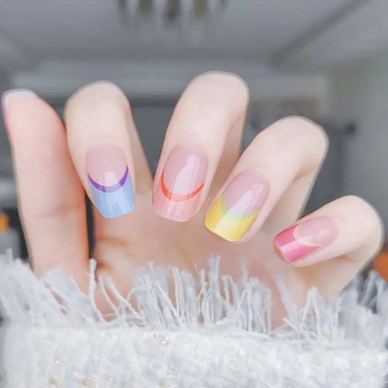 Rainbow French Tip Gel Nail Wraps featuring vibrant multi-colored tips for a playful manicure.
