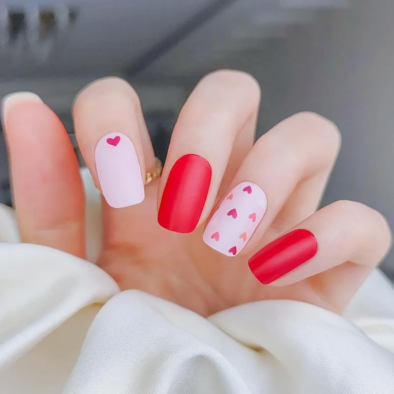 Red Valentine Gel Nail Wraps featuring heart patterns and a romantic red-pink design for Valentine’s Day.