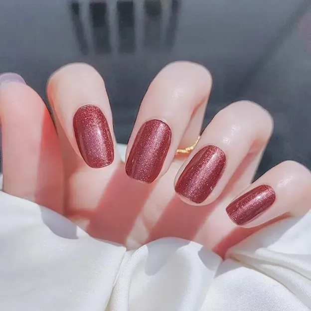 Rusty Rose Gel Nail Wraps featuring a shimmering warm red finish, perfect for an elegant manicure.