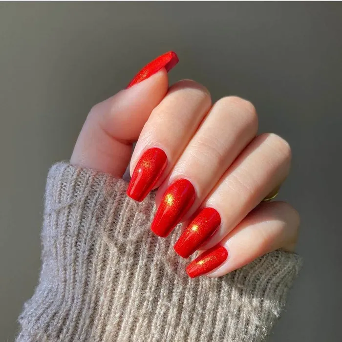 Shimmer red gel nail wraps with a glossy and sparkly finish for an elegant DIY nail art look.