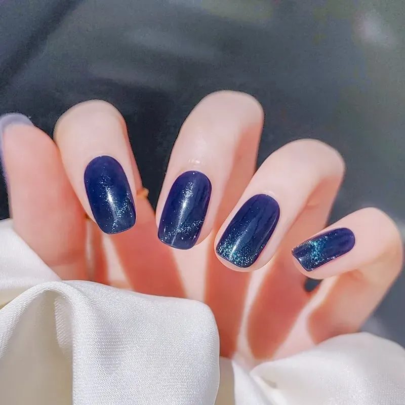 Starlit Sapphire Gel Nail Wraps with a dazzling blue cat-eye shimmer, perfect for creating a starry night-inspired manicure.