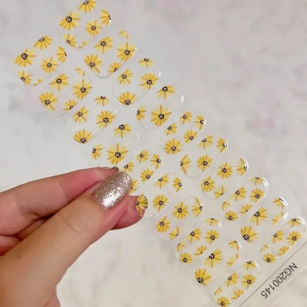 Sunny Blossom Gel Nail Wraps with yellow floral design for spring and summer manicures.