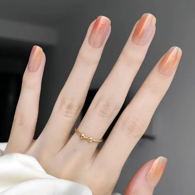 Sunset Glow Gel Nail Wraps with a gradient orange and gold shimmer design for summer-inspired manicures.