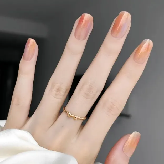 Sunset Glow Gel Nail Wraps with a gradient orange and gold shimmer design for summer-inspired manicures.