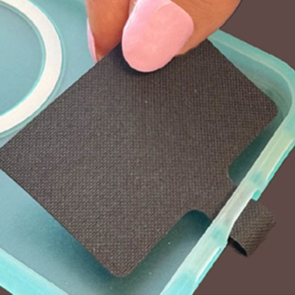 Step 1: Place the phone tether insert between the phone and its case, with the tab through the charging port