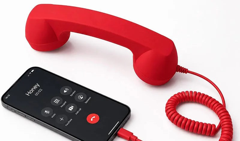 Red retro handset connected to a smartphone with a Type-C plug