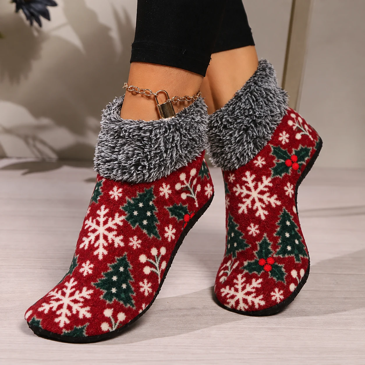 Red Christmas fuzzy socks worn indoors with black leggings