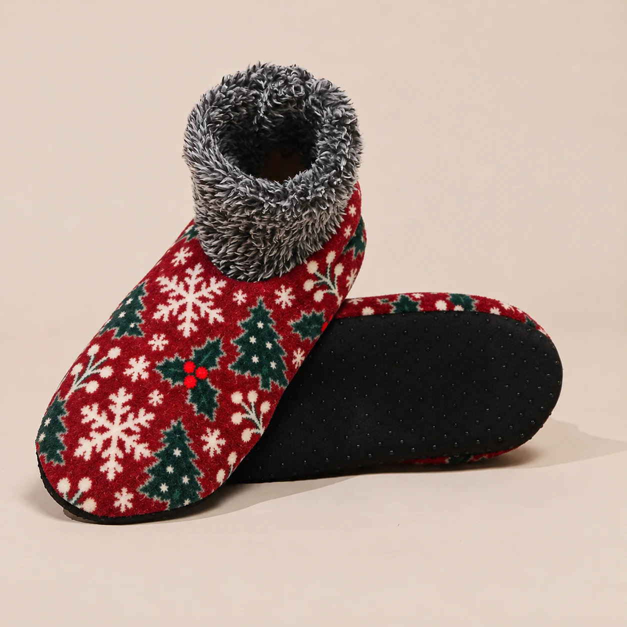 Side and underside view of red Christmas house sock showing black grip sole