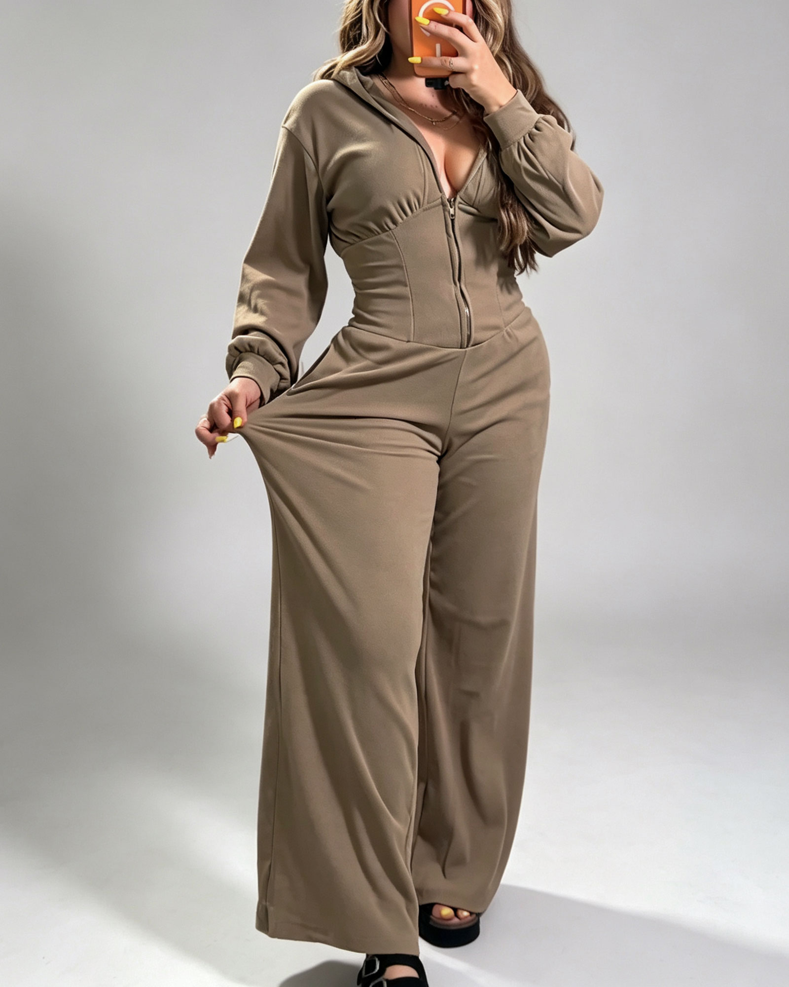 Hooded Zippered Front Opening Long Sleeved Wide Leg Jumpsuit With A Fitted Waist