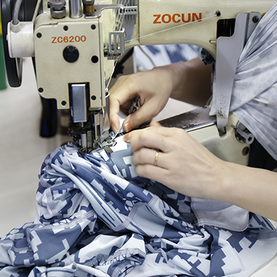 {"default":"Skilled worker sewing swimwear panels with industrial sewing machine"}
