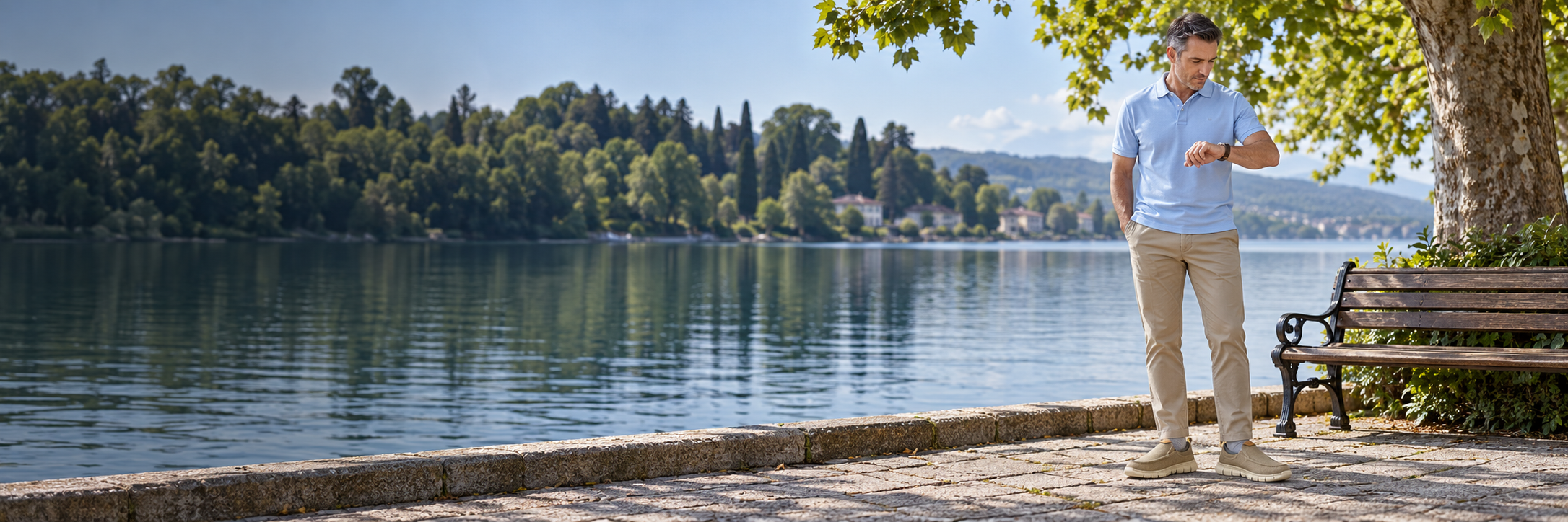 Mature man wearing khaki canvas loafers beside a lakeside promenade