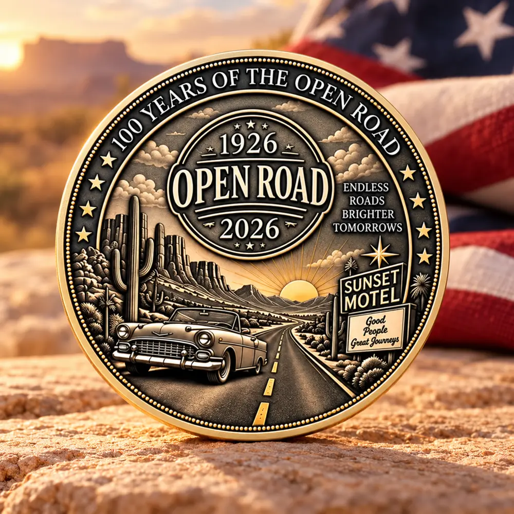 Open Road centennial coin standing against a sunset and American flag setting