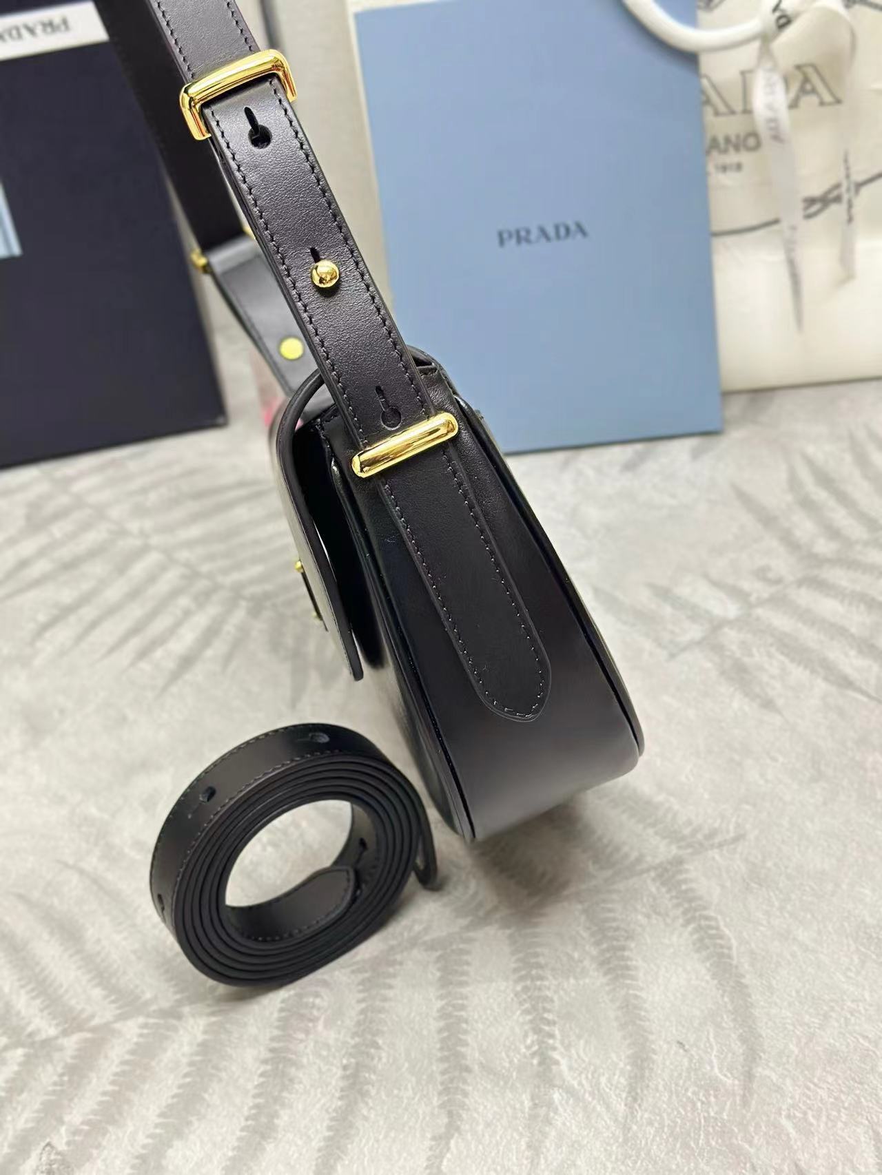 Prada Arqué leather shoulder bag with flap