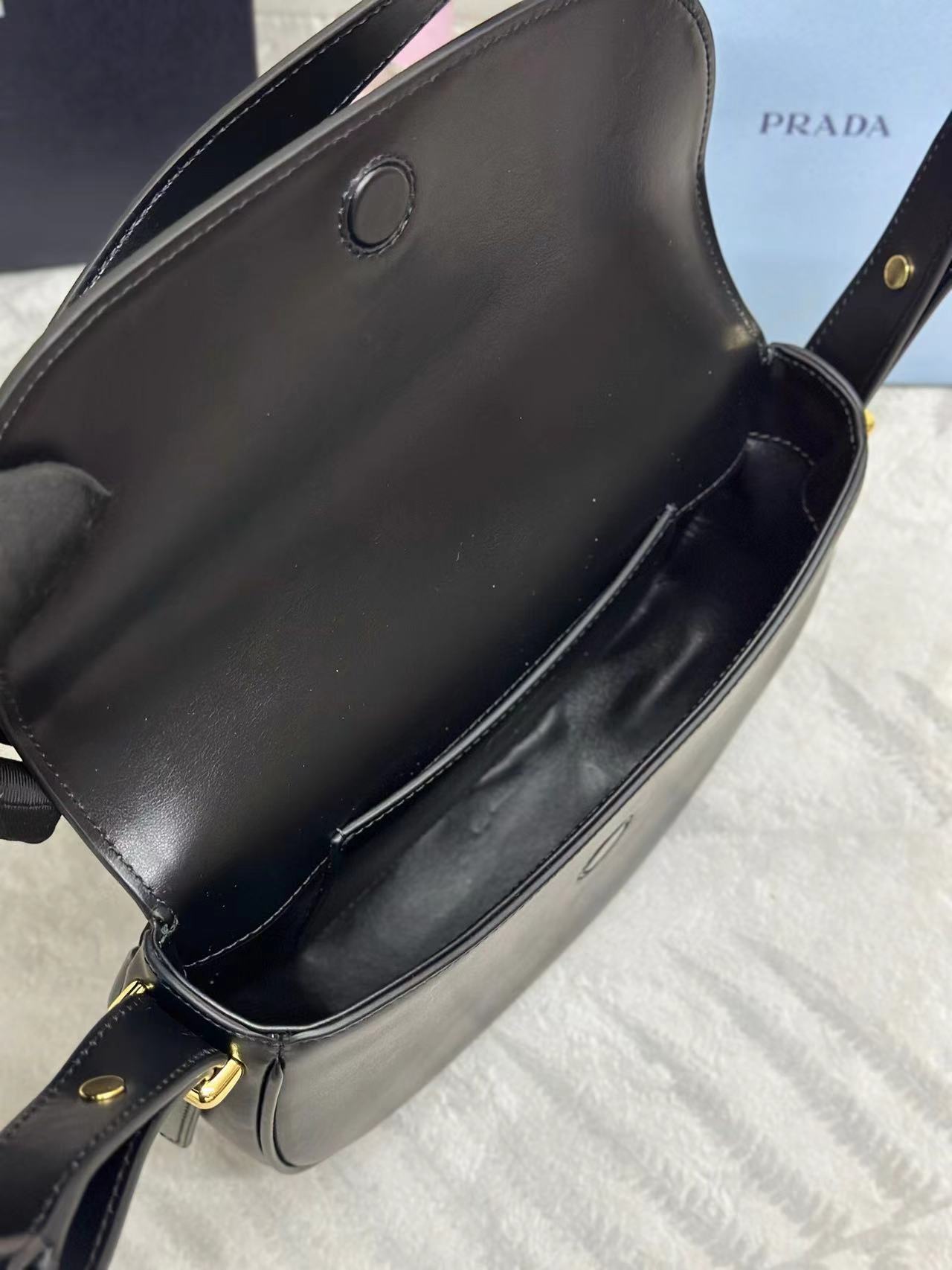 Prada Arqué leather shoulder bag with flap