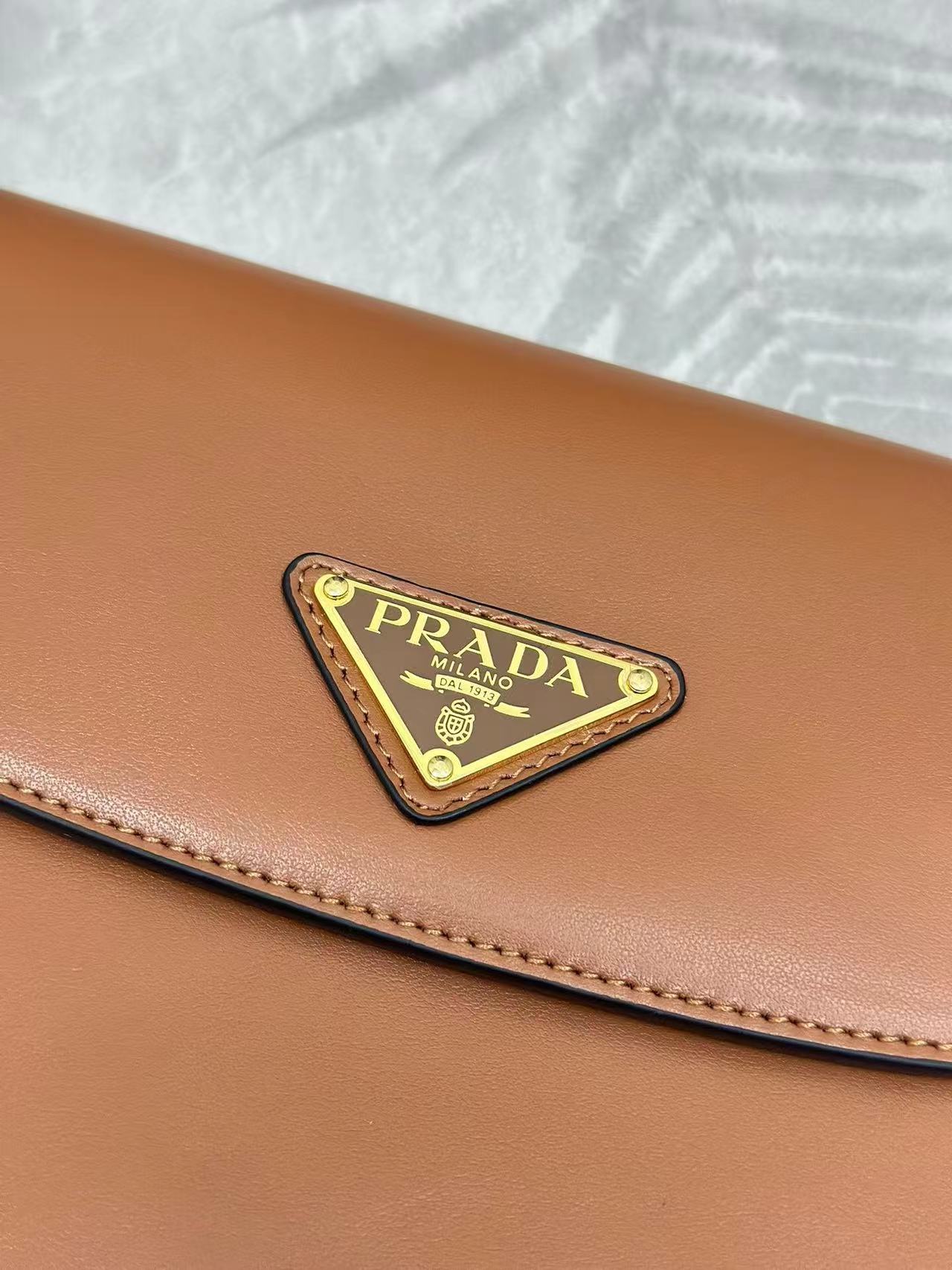 Prada Arqué leather shoulder bag with flap