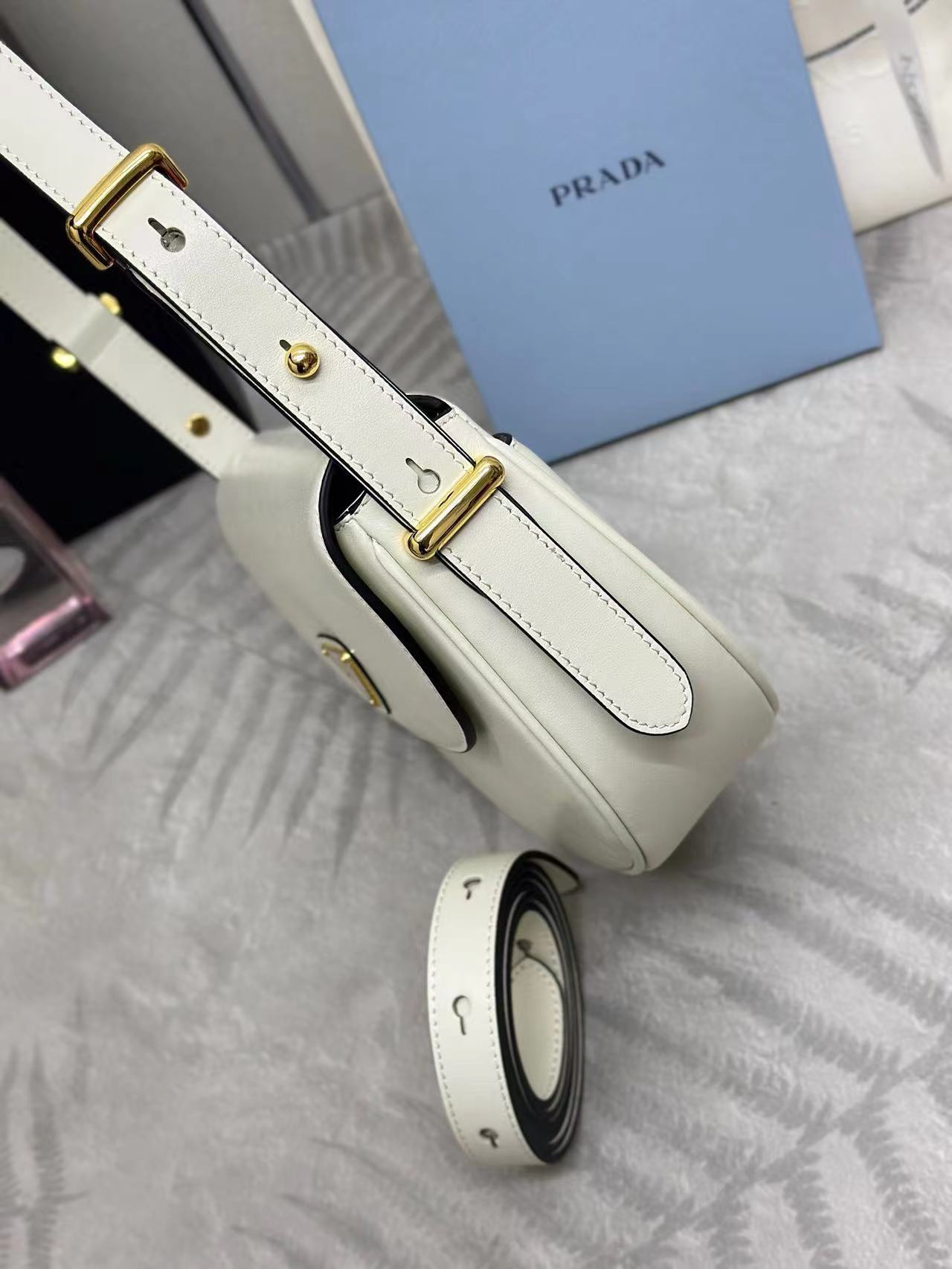 Prada Arqué leather shoulder bag with flap